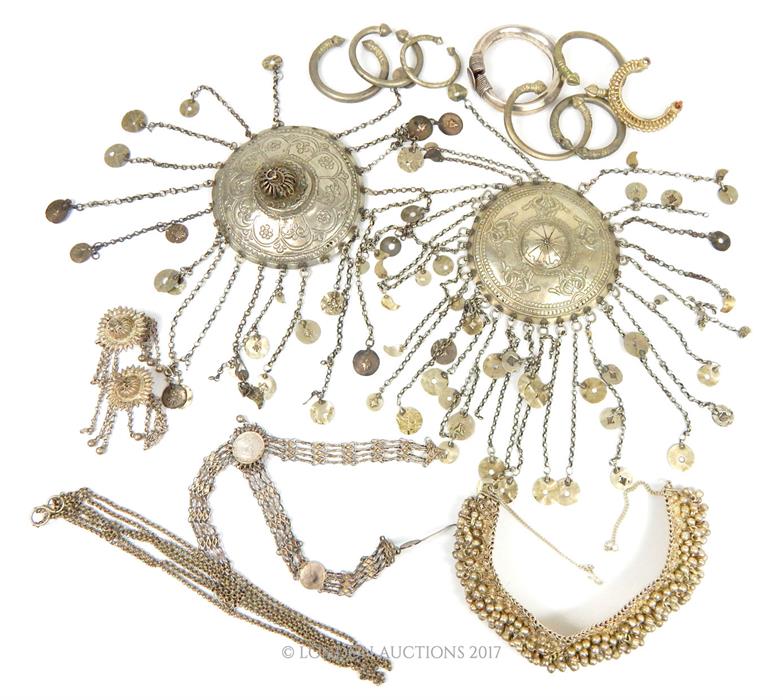 A collection of Indo-Persian white metal jewellery, some set with Indian Rupees.