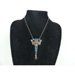 A silver and enamel Art Nouveau style necklace on a silver chain.