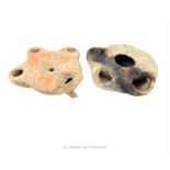 Two Roman earthenware oil lamps