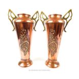 A pair of Arts and Crafts copper vases, having twin pierced handles