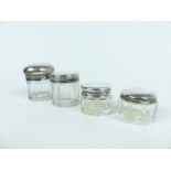 Four, cut glass and sterling silver-lidded, dressing table jars