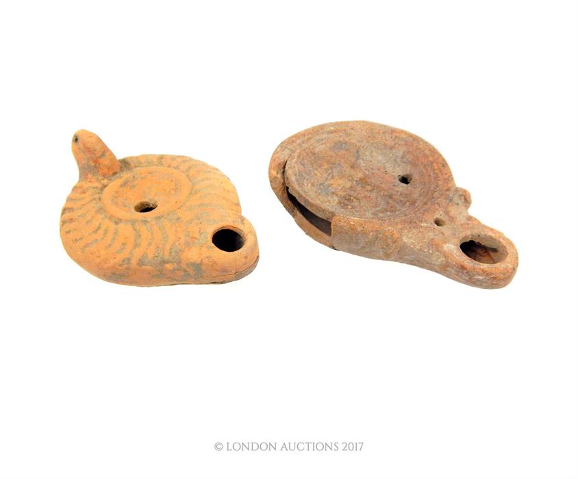 Two Roman terracotta oil lamps