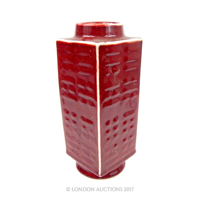 A Chinese porcelain Cong vase, having a sang de bouef glaze