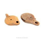 Two Roman terracotta oil lamps