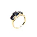 A 9 ct yellow gold, diamond and garnet ring