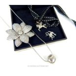 A collection of jewellery including a silver flower brooch,