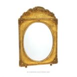 A rectangular, gilt, easel mirror with oval plate glass