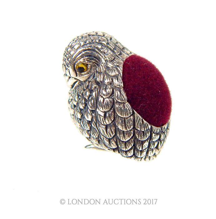 A sterling silver pin cushion in the form of a baby bird