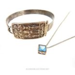 A silver bangle and a necklace