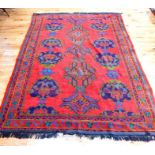 A Turkish Ushak carpet, having a bright red field, surrounded by one frieze and four running