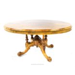 A 19th century, oval-shaped, burr-walnut dining table