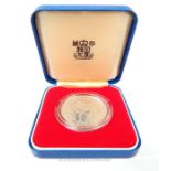 A boxed, large, sterling silver coin commemorating the Queen's Jubilee 1977
