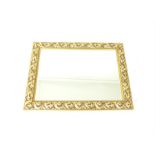 A large, ornamental, gilt framed mirror with bevelled glass mirror plate