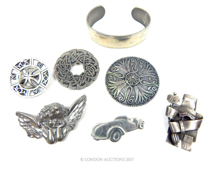 A collection of pewter jewellery items