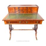 A mahogany writing desk with green, tooled leather writing base