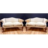 A PAIR OF EARLY 18TH CENTURY DESIGN TWO SEAT SETTEES, with humpbacks and scroll arms , raised on