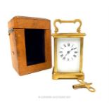 A 20th CENTURY GILT BRASS CARRIAGE CLOCK AND LEATHER TRAVEL CASE; having four bevelled glass