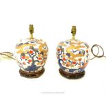 A pair of Chinese porcelain table lamps, painted in the Japanese Imari manner