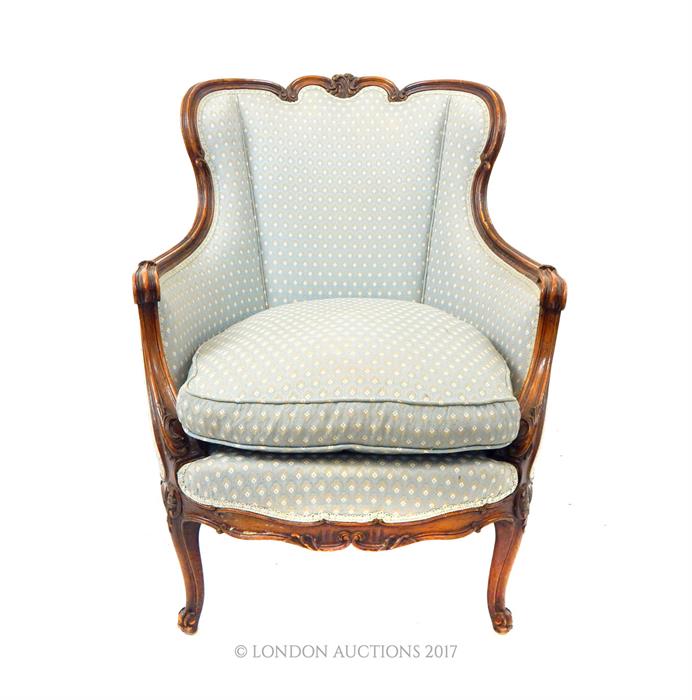 An elegant, French armchair in pale blue upholstery with matching seat cushion