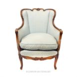 An elegant, French armchair in pale blue upholstery with matching seat cushion