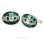 A pair of sterling silver and green enamel cufflinks