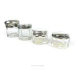 Four, cut glass and sterling silver-lidded, dressing table jars