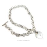 A sterling silver chain with a heart adornment