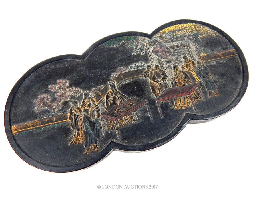 A Chinese moulded inkstone decorated with a court scene