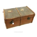 A vintage brown trunk, having wooden banding on the top and sides