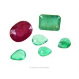 A collection of loose, natural, ruby and emerald gemstones