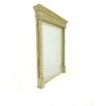 An antique, grey-painted, over mantle mirror with bevelled glass and reeded columns