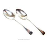 A pair of solid silver, Old English-style serving spoons