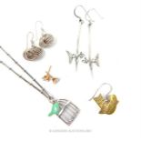 Three pairs of silver earrings and a necklace