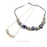 A silver necklace together with a necklace threaded with beads