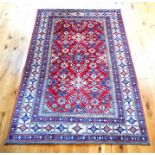 A Kazak rug, having a red ground