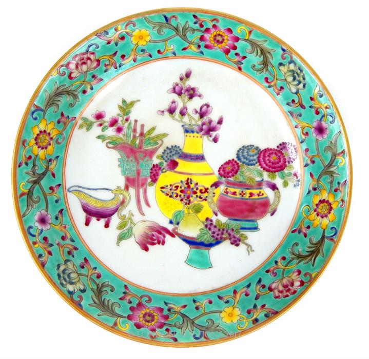 A Chinese porcelain dish, hand painted in the famille rose pallette