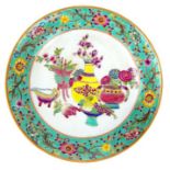 A Chinese porcelain dish, hand painted in the famille rose pallette
