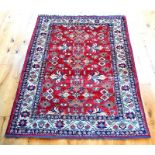 A Kazak rug, having a red field