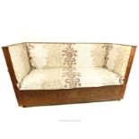 A striking, Continental settee with carved wooden ends