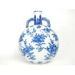 An attractive, Chinese, blue and white moon flask decorated with pomegranates
