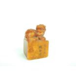 A Chinese, deep orange, carved, soapstone seal with snarling Dog of Fo on top
