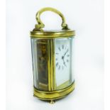 A late, 19th century, polished brass, oval-shaped carriage clock