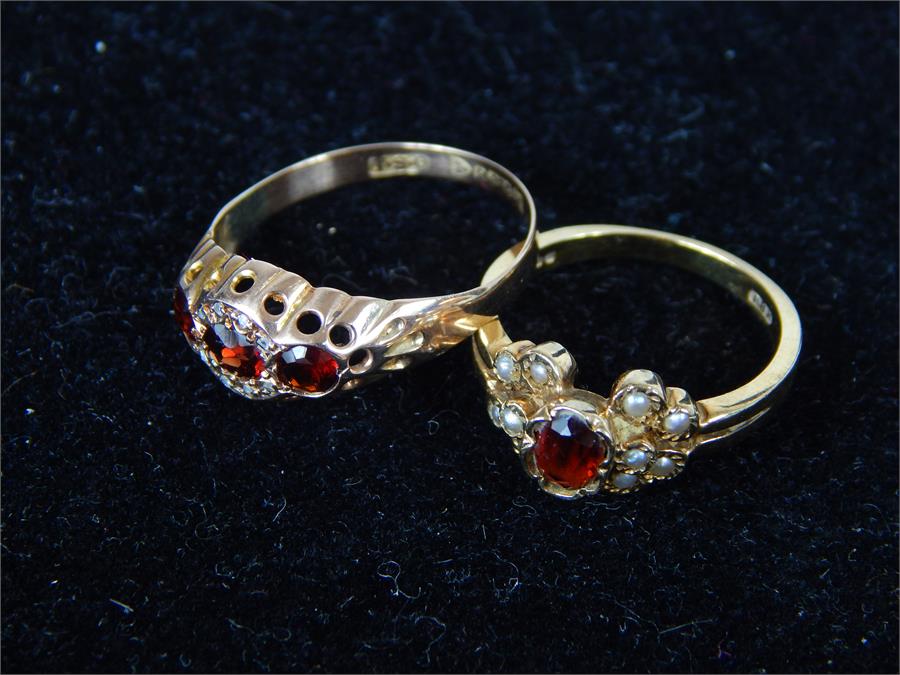 Two 9 ct yellow gold and garnet rings