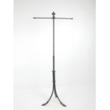 A 19th century, cast metal stand on an elegant tri-pod base