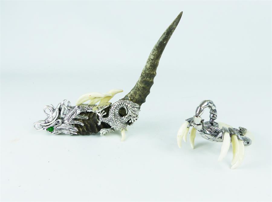 Two, oriental, white metal, tusk and claw animal sculptures