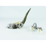 Two, oriental, white metal, tusk and claw animal sculptures