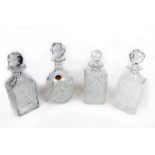 Four, elegant, cut and pressed glass decanters with stoppers