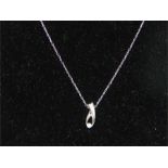 A white gold pendant necklace in the form of jewellers' tweezers.