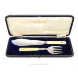 A George V cased pair of sterling silver fish servers with ivory handles