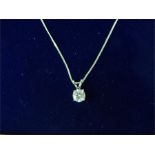 A white gold single stone diamond pendant necklace.